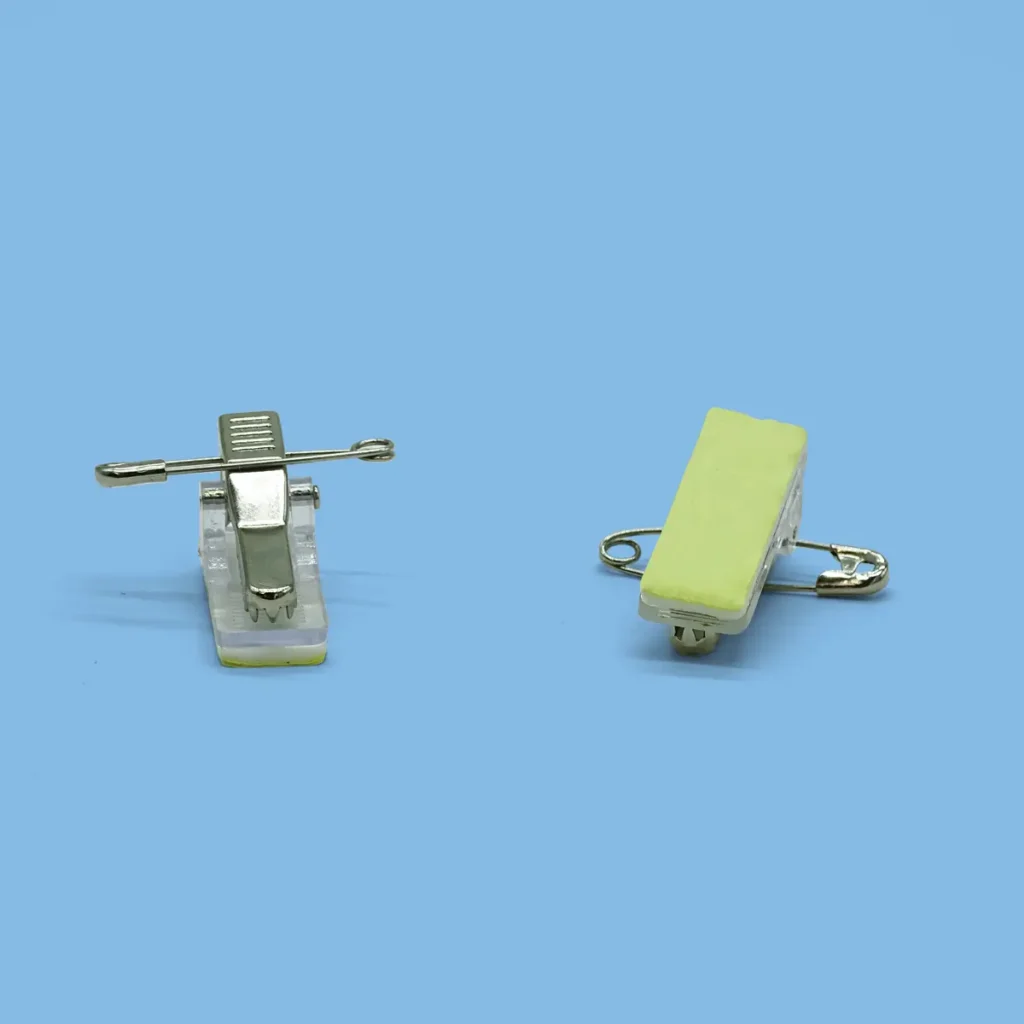 Pins and clips for badge attachment