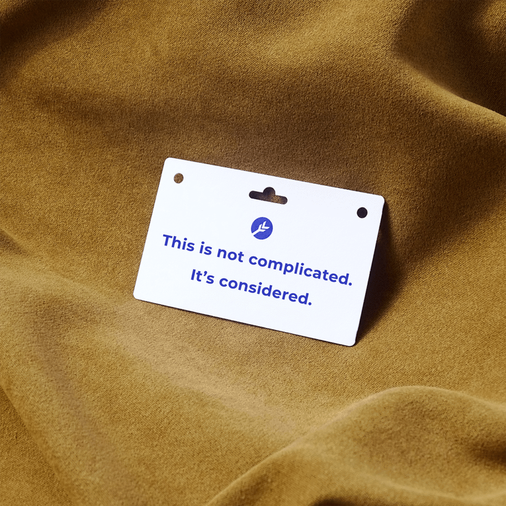 A sustainable event badge with the slogan "This is not complicated. It's considered" on it